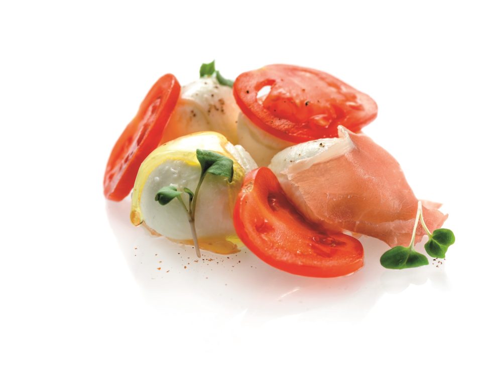 Tomato with cream made of mozzarella and basil