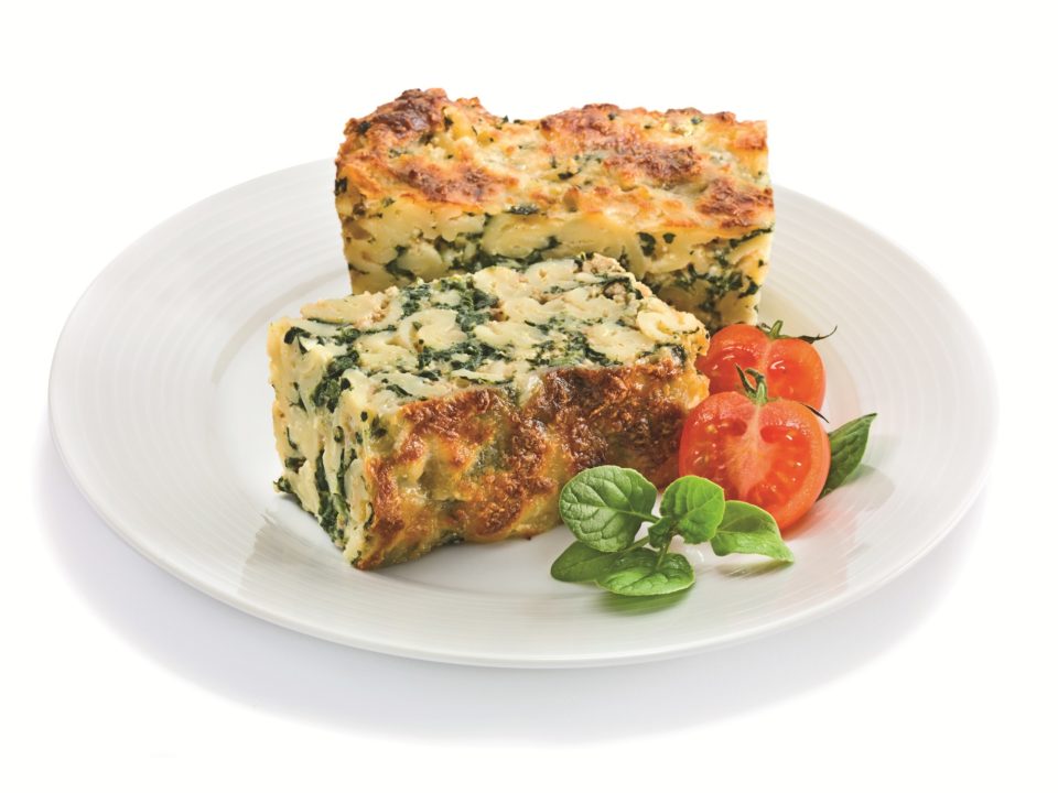 Baked pasta with spinach, grated mozzarella and walnuts